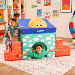 Two toddler boys playing with colorful foam play shapes known as Cloud Castle