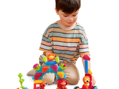 A kid playing with colorful, sensory building blocks.